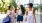a group of women walking down a sidewalk holding drinks